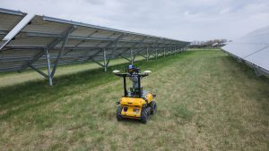 Husky Observer navigating between solar panels.